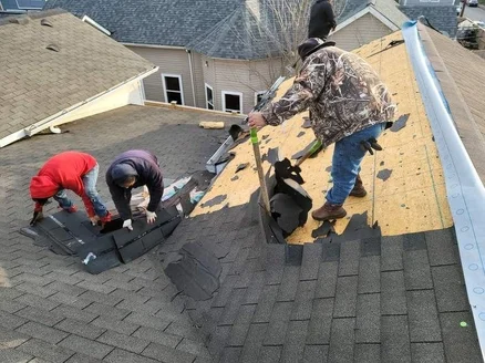 Roof replacement crew performing tear-off and installation